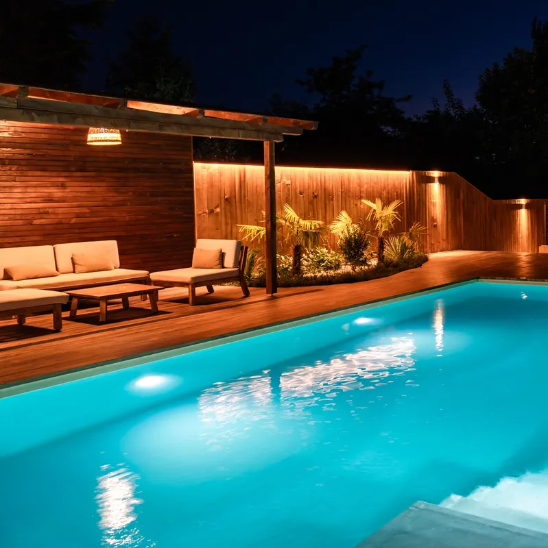 Cozy illuminated poolside seating area