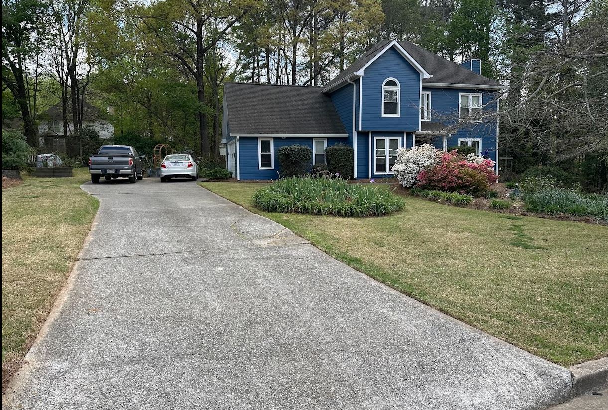 Freshly mowed lawn next to driveway